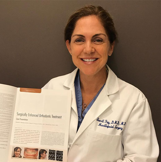 Sherrill Fay, DMD, MD holding magazine